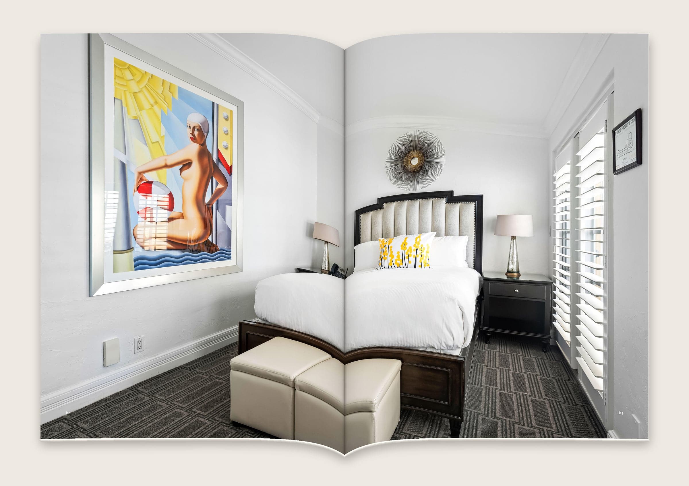 Photograph across a spread of a guest room with a large painting, a tufted headboard and white shutters.