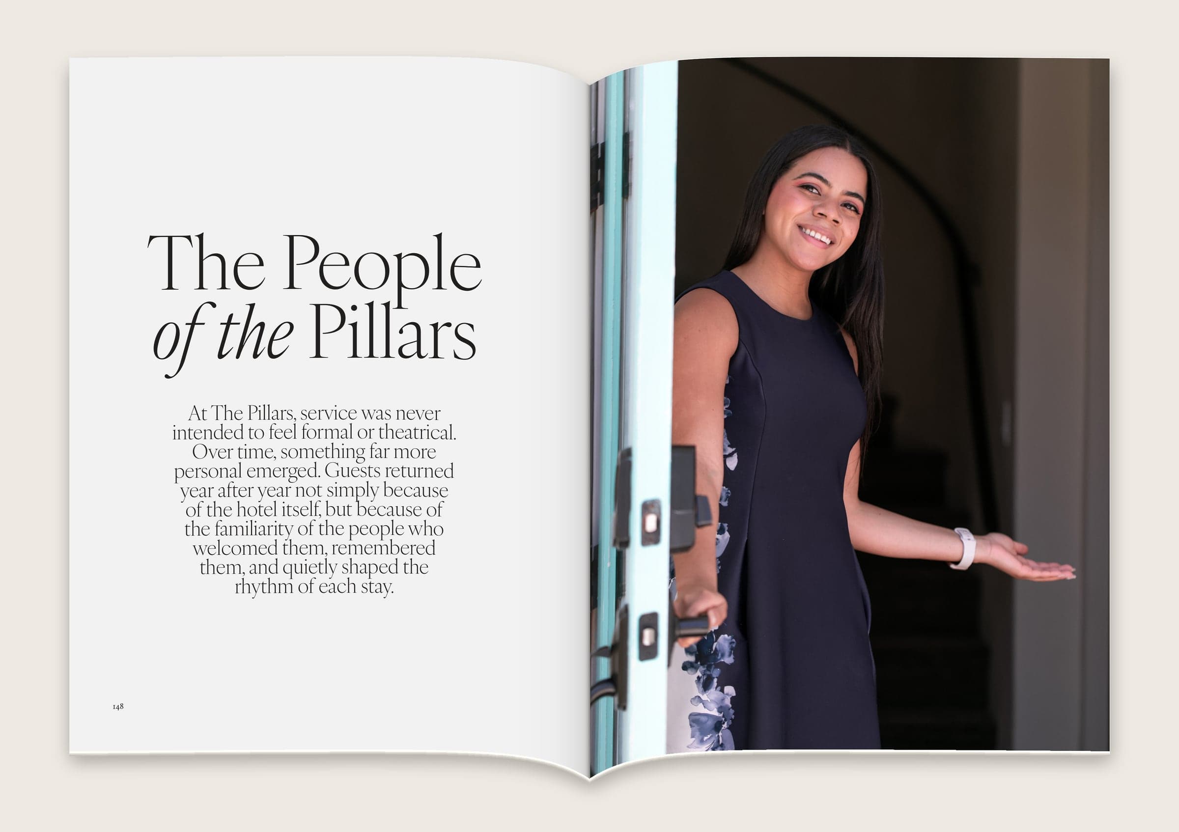Spread titled “The People of the Pillars” with a smiling member of staff holding the front door open.